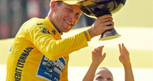 In this July 24, 2005 file photo, Luke Armstrong, rear right, tries to touch the winner's trophy held by his father, Lance Armstrong, after Armstrong won his seventh straight Tour de France cycling race, in Paris. (AP Photo/Peter Dejong, File)