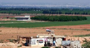 Syrian soldiers at a Syrian army post as seen from the Lebanese border village of al-Qasr, Lebanon, Friday, April 12, 2013. (AP Photo/Bilal Hussein)