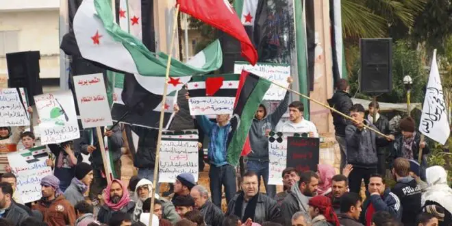 Anti-Syrian regime protesters hold up banners during a demonstration, in Idlib, Syria, Friday, March 2, 2012. (AP Photo/Local Coordination Committees in Syria