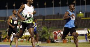 Usain Bolt (L) crosses the finish line during the men's 200 meters semi-final event at the Jamaican Olympic trials in Kingston city, June 30, 2012. REUTERS/Gilbert Bellamy (JAMAICA - Tags: SPORT ATHLETICS OLYMPICS)