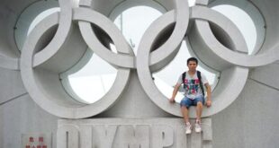 In a photo taken on July 26, 2012 tourist Wu Qian poses for a photo at the Olympic park in Beijing. AFP PHOTO/Ed Jones