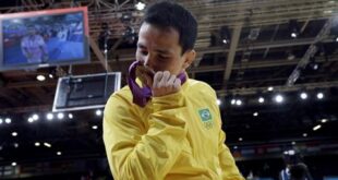 Felipe Kitadai, of Brazil, kisses his bronze for the men's 60kg judo competition at the 2012 Summer Olympics, Saturday, July 28, 2012, in London. (AP Photo/Paul Sancya)