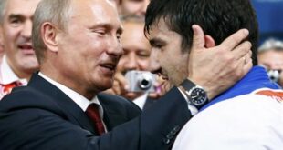 Russian President Vladimir Putin (L) congratulates Russia's Tagir Khaibulaev after he defeated Mongolia's Tuvshinbayar Naidan in their men's -100kg final judo match at the London 2012 Olympic Games August 2, 2012. (REUTERS/Darren Staples)