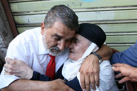 One of the Lebanese Shiite pilgrims that Syrian rebels have been holding hostage in Syria, hugs his mother, right, upon arrival at his house in the southern suburb of Beirut, Lebanon. (The Daily Star/Hasan Shaaban)