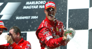 FILE - Photo taken on August 15, 2004 shows German Ferrari driver Michael Schumacher jubilate in the pits of the Hungarian Grand Prix in Budapest, Hungary. (AFP PHOTO FERENC ISZA)