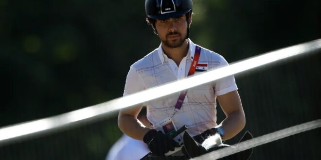 Small protest greets Syrian Olympian