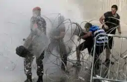 Riot police charge 'YouReek' protest, 1 hurt